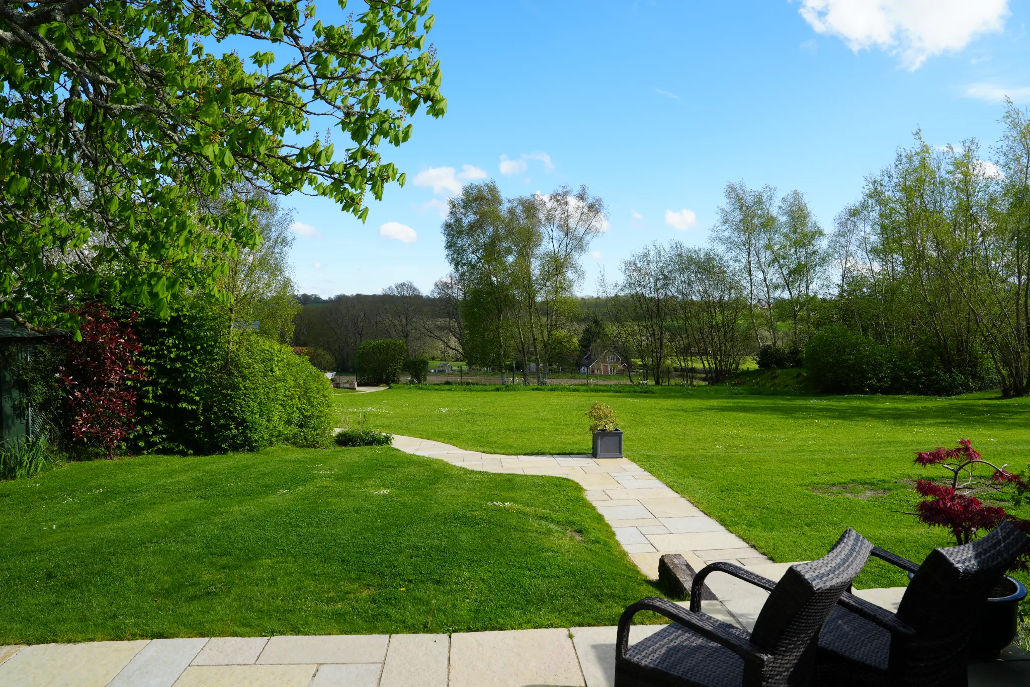 Terrace seating and garden path at Little Rose.