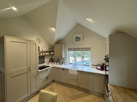Kitchen at Little Rose with vaulted ceiling and shaker cabinetry.